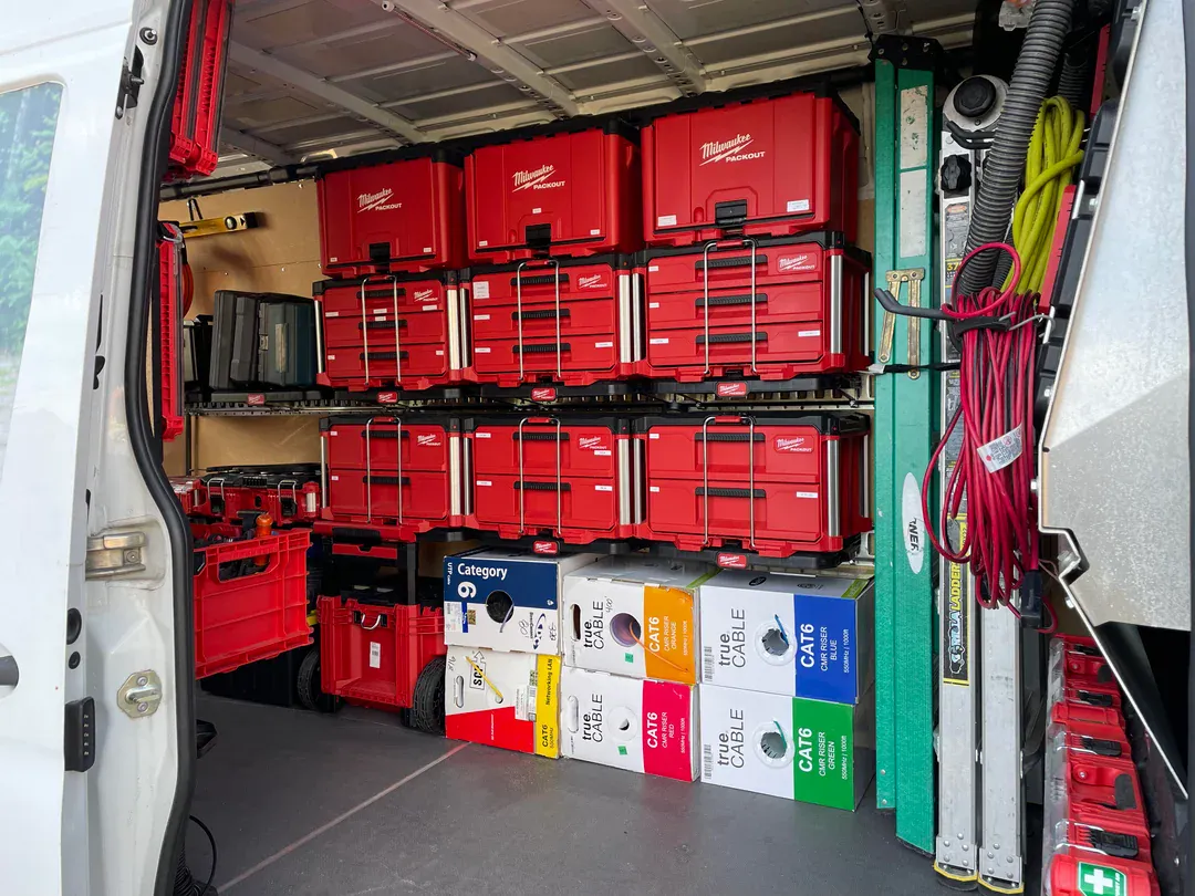 Organized Elvium service van with Milwaukee tool storage and cabling supplies